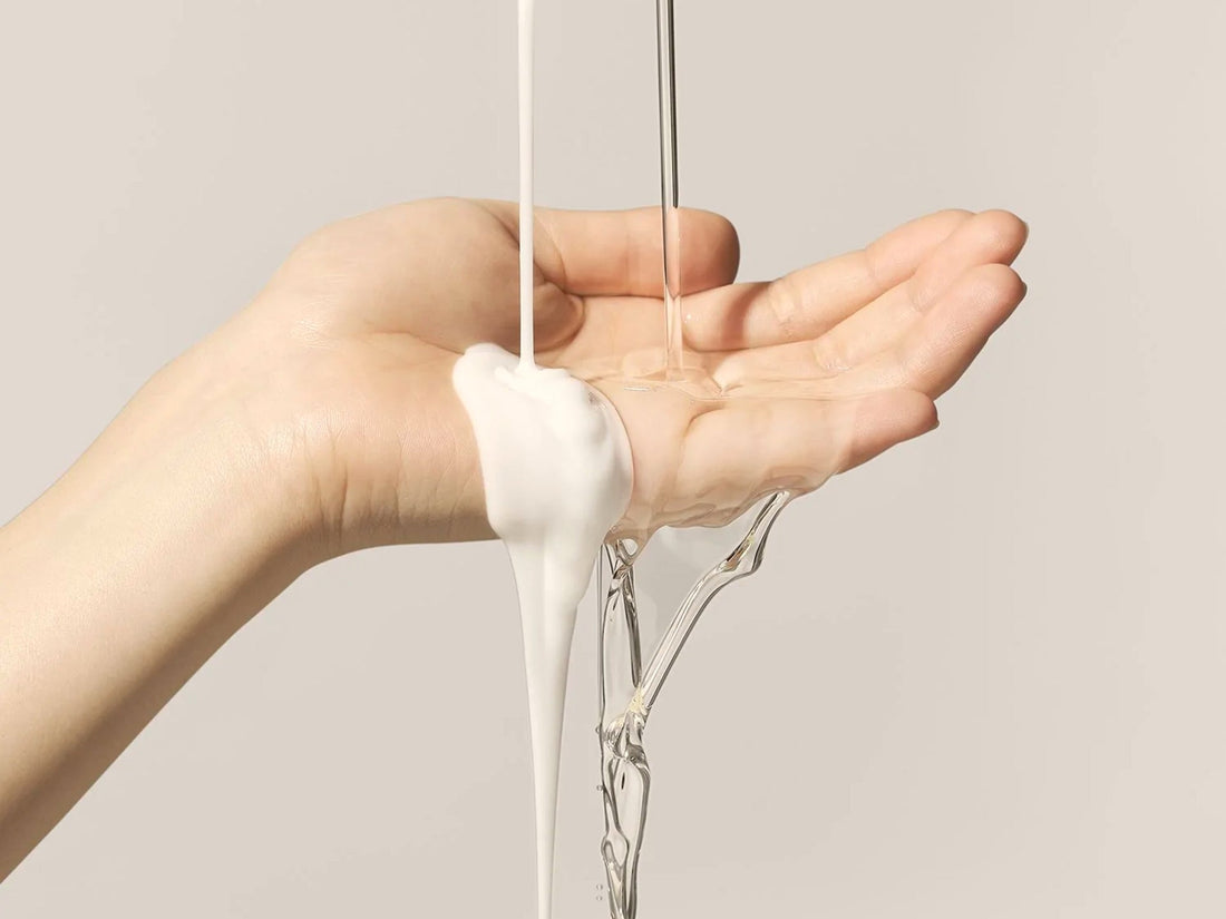 Image of a hand with shampoo and water dripping down