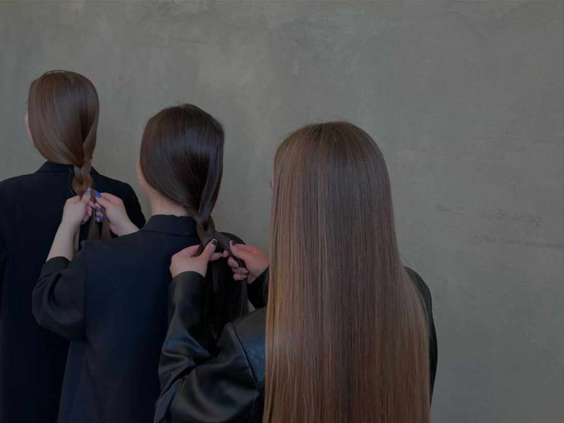 Image of 3 women braiding their long, dark hair