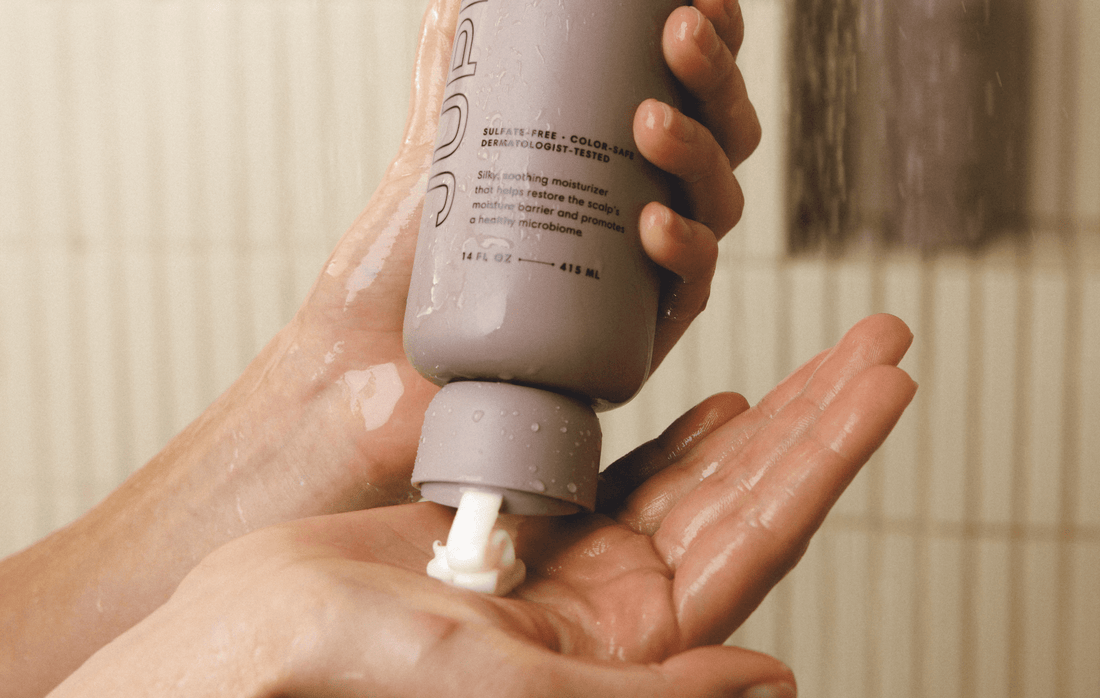 Photo of the Anti-dandruff Nourishing Conditioner being dispensed on the palm of a hand