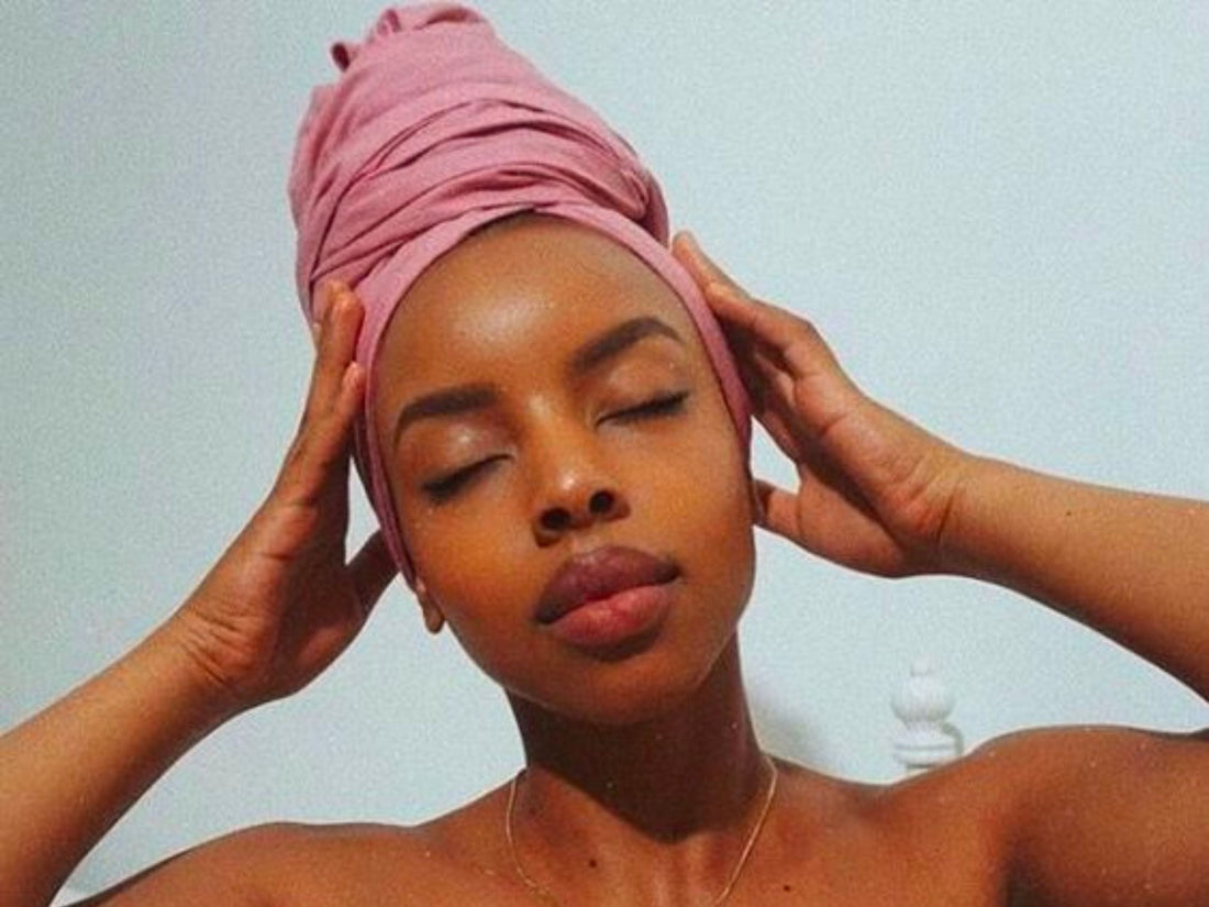 Image of a woman with her hair wrapped in a towel