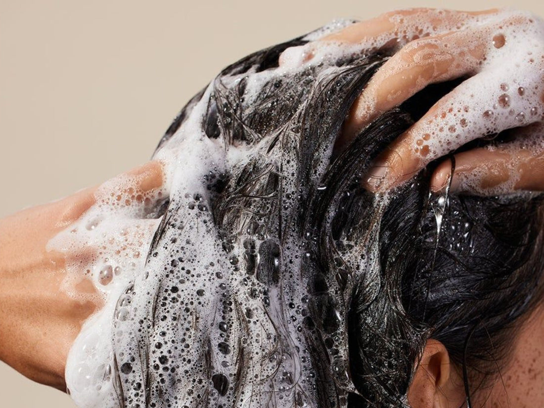 Image of woman shampooing her hair