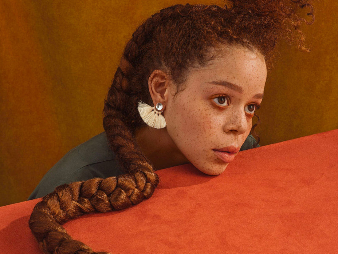 Image of a woman with her long braid on the table top