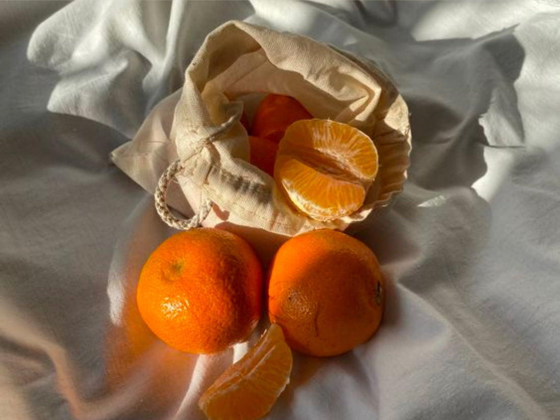 Image of oranges on top of white fabric