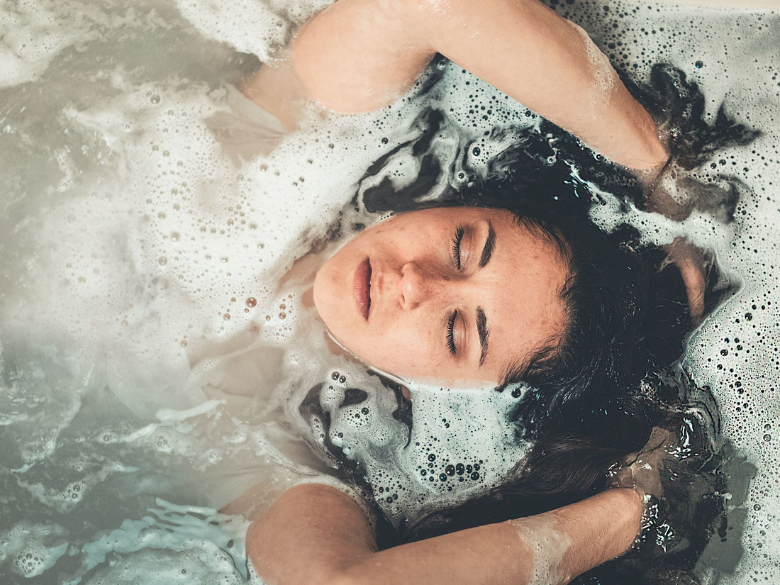 Image of a woman in a bathtub submerged in bubbly water
