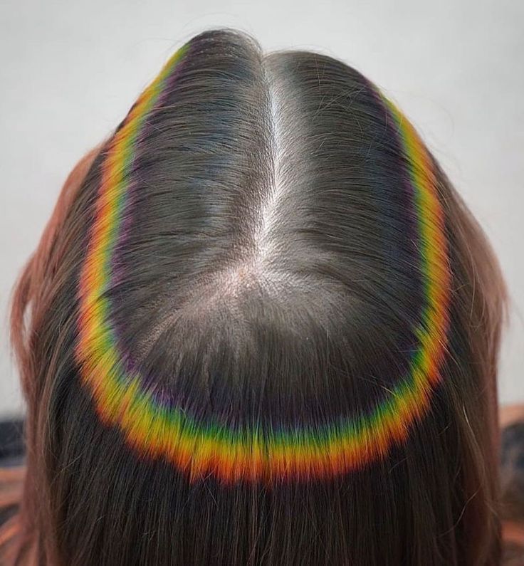 Image of a woman's scalp with a rainbow reflection