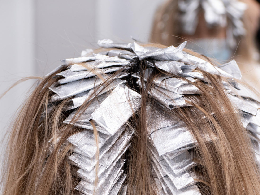 Photo of a woman getting a color/chemical treatment on her hair